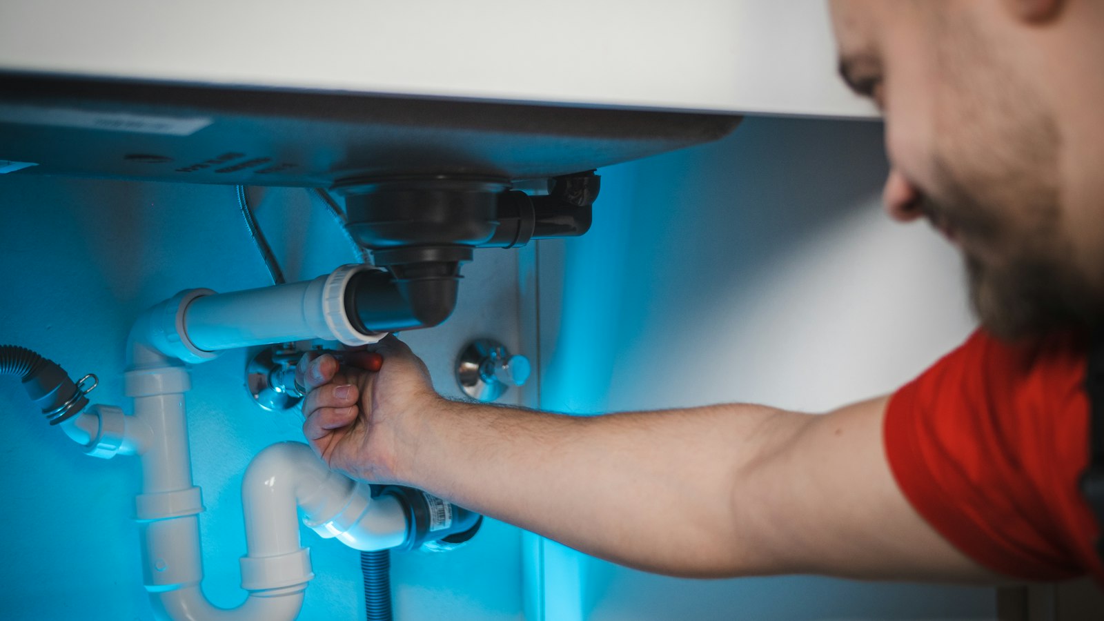 Plumber repairing a sink drain